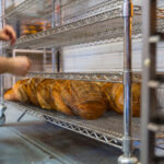 Steel wire shelving used for bread loaves.