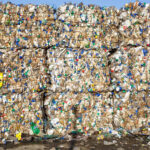 Plastic bales at waste processing, held together with bale ties.