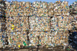 Plastic bales at waste processing, held together with bale ties.