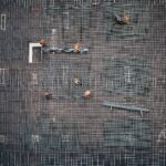 Construction workers working on wire mesh installation.
