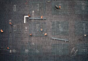Construction workers working on wire mesh installation.