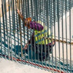 Construction worker behind construction wire rods